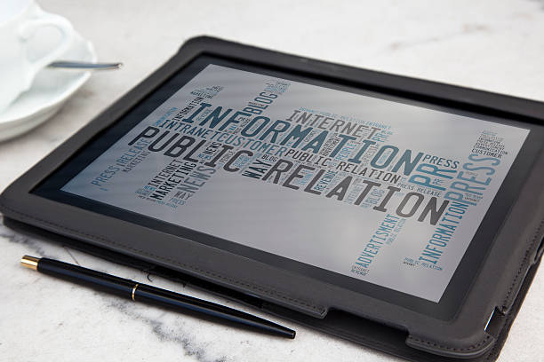 tablet with public relation word cloud stock photo