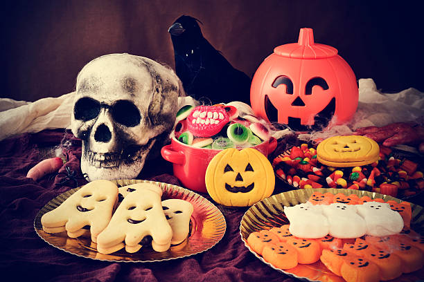 istock cookies and candies on an ornamented table for Halloween 493505198
