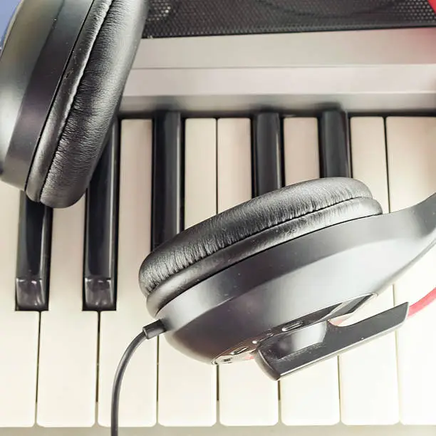 Photo of headphones on electric piano keyboard