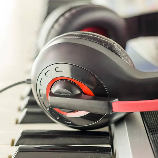 Photo of headphones on electric piano keyboard