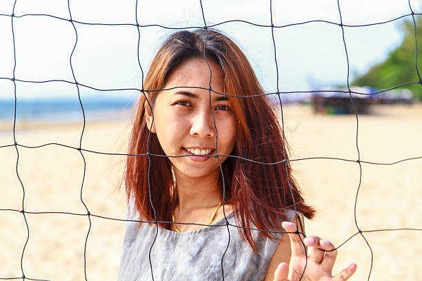 Pretty girl asian with Volleyball Nets Pretty girl asian with Volleyball Nets and look at the camera modle stock pictures, royalty-free photos & images