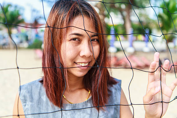Pretty girl asian with Volleyball Nets Pretty girl asian with Volleyball Nets and look at the camera modle stock pictures, royalty-free photos & images