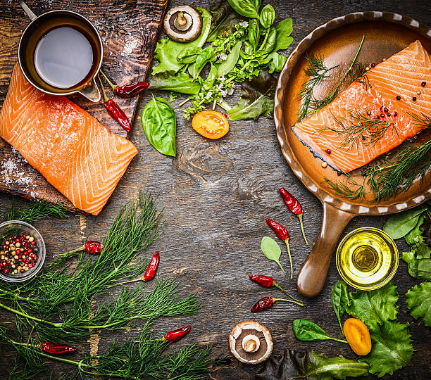istock Salmon fillet on rustic table with fresh ingredients for cooking 493509776