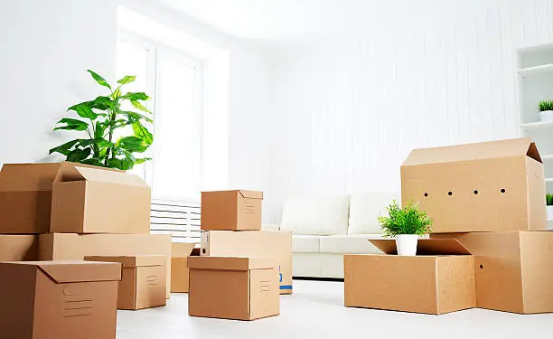 move. lots of cardboard boxes in an empty new apartment