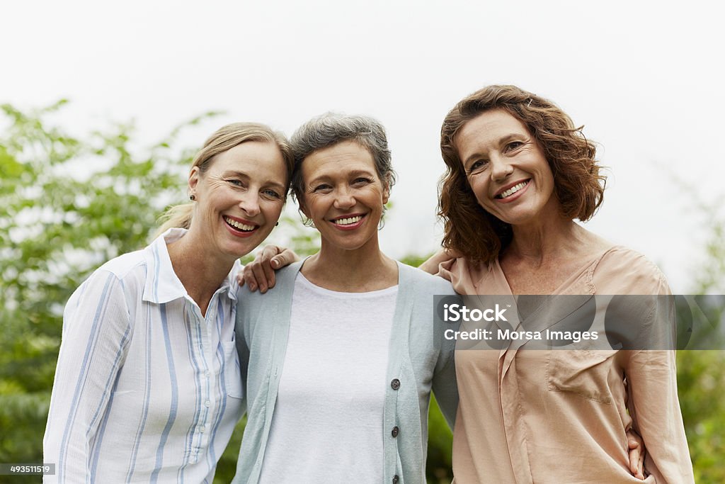 Happy mature women standing in park Portrait of happy mature women standing together in park Only Women Stock Photo