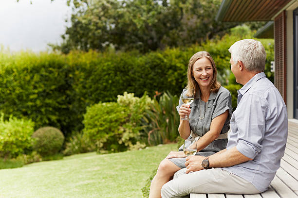 Couple enjoying wine Happy mature couple enjoying wine at yard drinks on the deck stock pictures, royalty-free photos & images