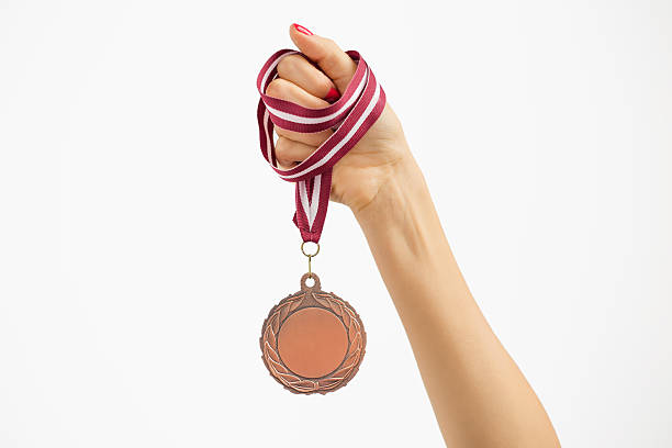 person holding eine medaille - bronze medal fotos stock-fotos und bilder