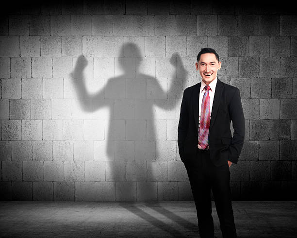 istock Asian business man casting a strong man shadow 493512868