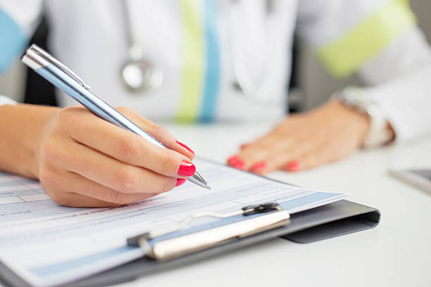 istock Woman doctor writing 493512988