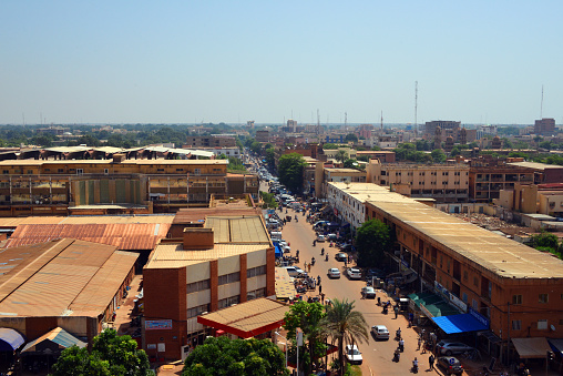 Ouagadougou, Burkina Faso - October 13, 2015: people and traffic along Maurice Yameogo avenue, the commercial center of the city
