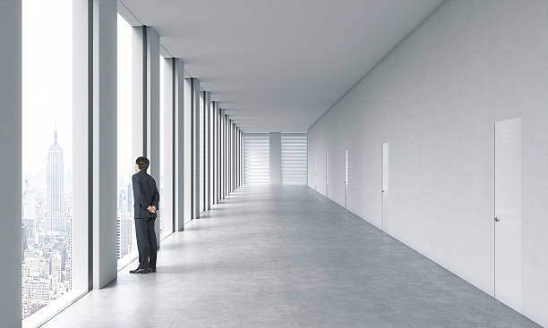 istock Young professional in formal suit is looking out the window. 493514498