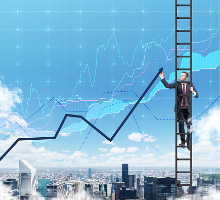 A businessman in a ladder is drawing a line chart as a summation of the finance tendencies. A finance charts are over New York city in the air.