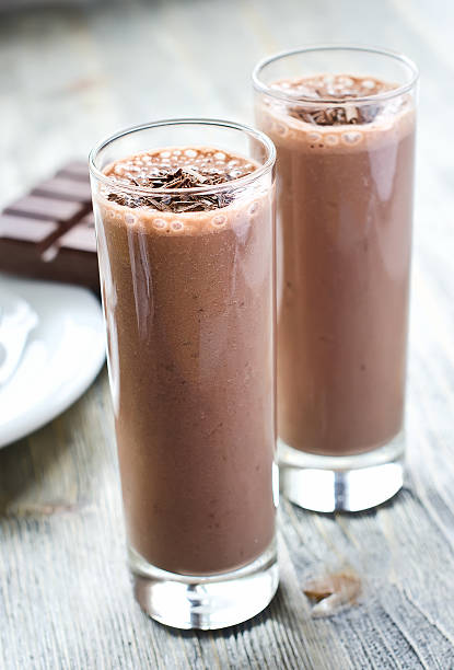 istock Chocolate smoothie in glasses on wooden background 493515298