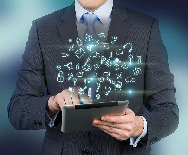 istock person holds a tablet with glowing mobile app icons 493516172
