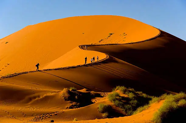 Tourists climbing Sossusvlei dune, Naukluft National Park, Namibia