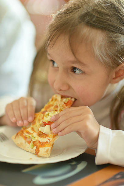 istock Little girl eating pizza 493528638