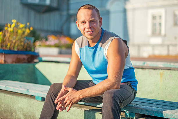 istock Sporting an attractive man sitting on bench and rests in 493529320