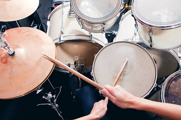 Personal Perspective Of Drummer A personal perspective of a woman playing a drum set. drummer hands stock pictures, royalty-free photos & images