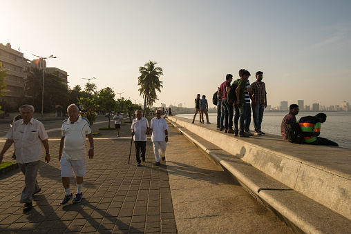 Mumbai, India - September 25, 2015: People of all age and sex gather at Marine Drive, Mumbai, for exercise and prayers.