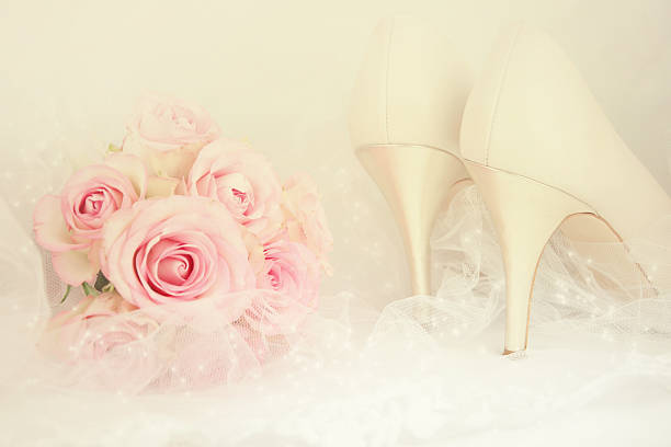Wedding Day concept with roses and bridal shoes.