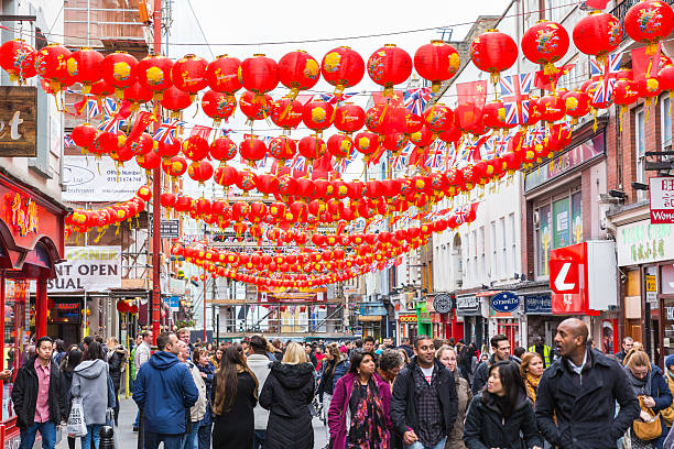 China Town in London London, UK - October 17, 2015: Crowded streets in China Town district. There are many red decorations over the road, with both Chinese and UK flags in honour of State Visit of Chinese president Xi Jinping xi jinping stock pictures, royalty-free photos & images