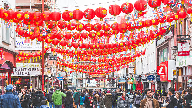 China Town in London London, UK - October 17, 2015: Crowded streets in China Town district. There are many red decorations over the road, with both Chinese and UK flags in honour of State Visit of Chinese president Xi Jinping xi jinping stock pictures, royalty-free photos & images