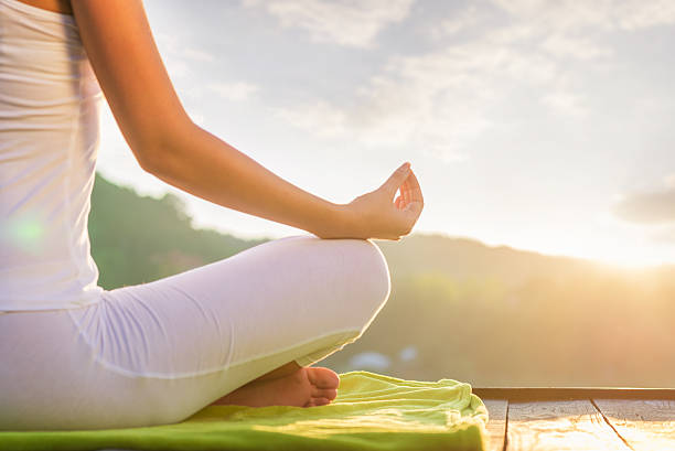 istock Woman doing yoga on the shore - half figure sitting 493535728