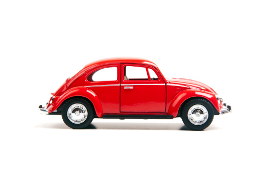 Izmir, Turkey - January 5, 2013: Red Vintage toy Volkswagen car close up image on isolated white background.