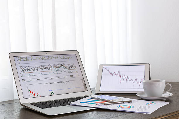 istock Laptop, tablet , smartphone and coffee cup with financial 493537807