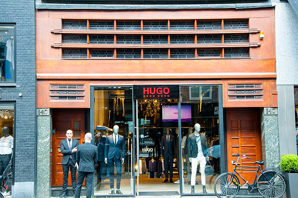 Hugo Boss store on the P.C.Hooftstraat shopping street in Amsterdam. Amsterdam, the Netherlands - April 30, 2015: Hugo Boss store on the P.C.Hooftstraat shopping street, people on the street. victoria beckham stock pictures, royalty-free photos & images
