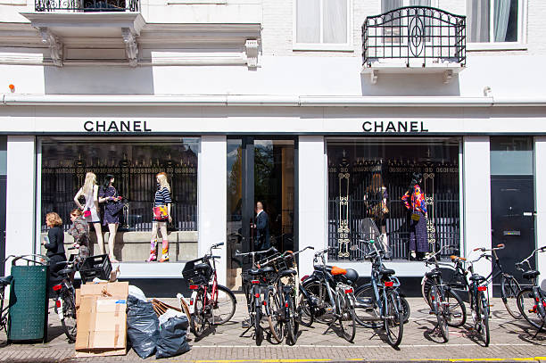 Chanel store on the P.C.Hooftstraat luxurious shopping street in Amsterdam. Amsterdam, the Netherlands - April 30, 2015: Chanel store on the P.C.Hooftstraat luxurious shopping street, people on the street. victoria beckham stock pictures, royalty-free photos & images