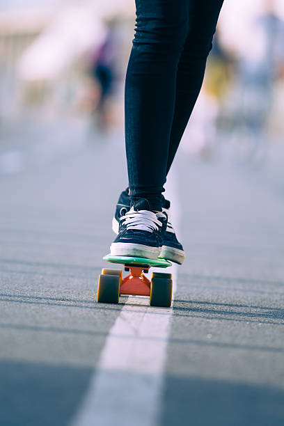 istock Close view of legs and skateboard 493538722