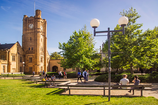 Melbourne, Australia - October 15, 2015: Students around the South Lawn of Melbourne University, before the Old Arts Clock Tower. 