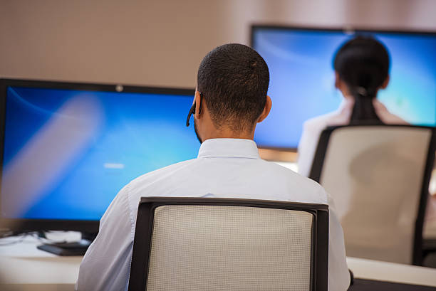istock Rear view of employee in customer support center 493539904