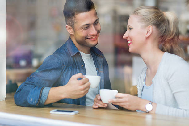istock Young couple seen through cafe window 493540094