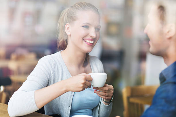 istock Couple drinking coffee in cafe 493540490
