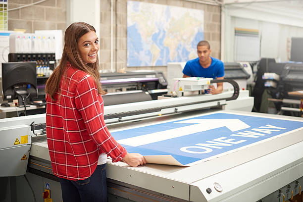 istock young woman working at a digital printers 493540854