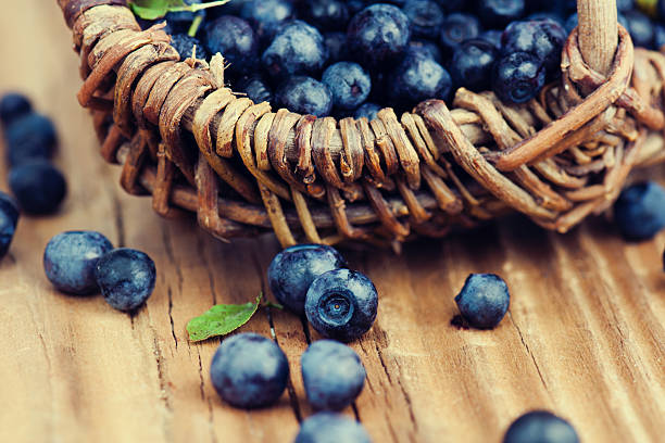istock Blueberries in basket on wooden background. 493541010
