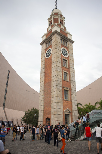 Hong Kong, Hong Kong SAR - October 14, 2013.  Tourists gather around the old Clock Tower in Tsim Sha Tsui district.  
