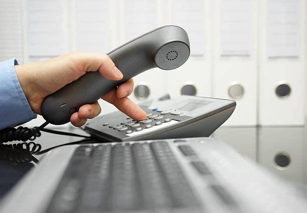 istock businessman  on the workplace is calling his  client 493548754
