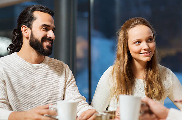 istock happy couple meeting and drinking tea or coffee 493550086