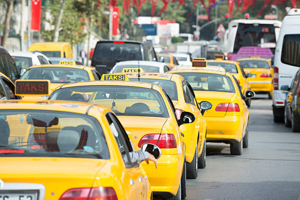 Istanbul Traffic Istanbul, Turkey - October 24, 2015: Yellow Taksi cabs line up in traffic along Kemeralti Caddis in the Beyoglu district of the city. yellow taxi cab stock pictures, royalty-free photos & images