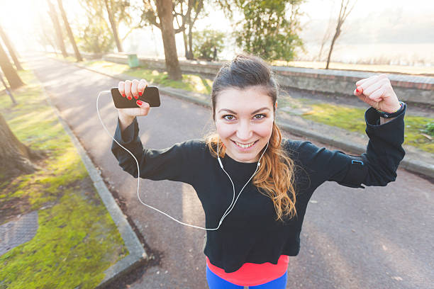 istock Successful woman with raised arms after workout 493552864