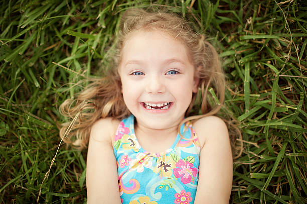 istock Cute little girl laughing. Top view. 493553294