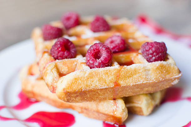 istock Waffles with raspberries and strawberry syrup 493554124