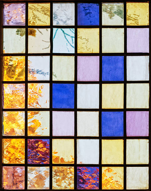 istock glass window of a church with tree in fall behind 493554238