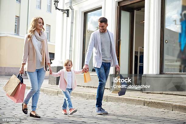 Happy Family With Child And Shopping Bags In City Stock Photo - Download Image Now - Family, Luxury, Shopping