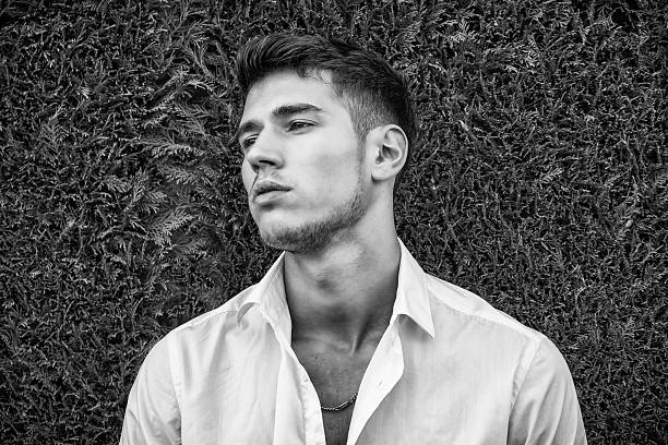 Portrait of stylish arab beard man wear grey turtleneck and black jaket. Arabian model guy against steel wall.
