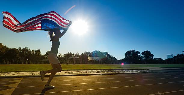 istock Girl Running With American Flag 493557330