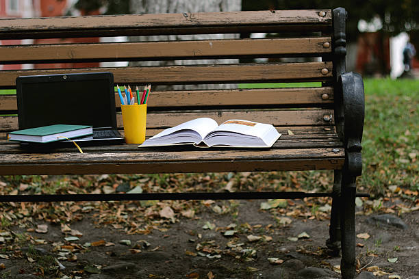 istock books on a bench in the school year 493557552